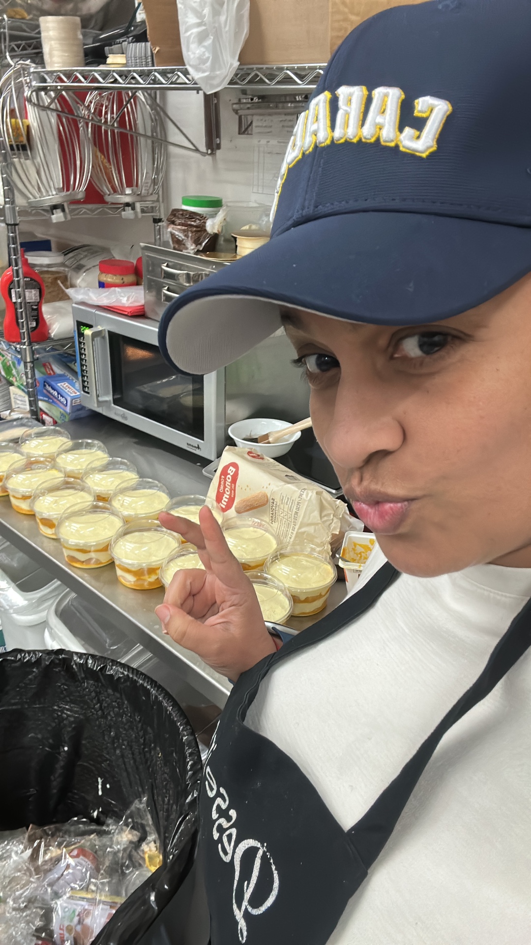 Clara, smiling in her kitchen, holding a freshly baked cake